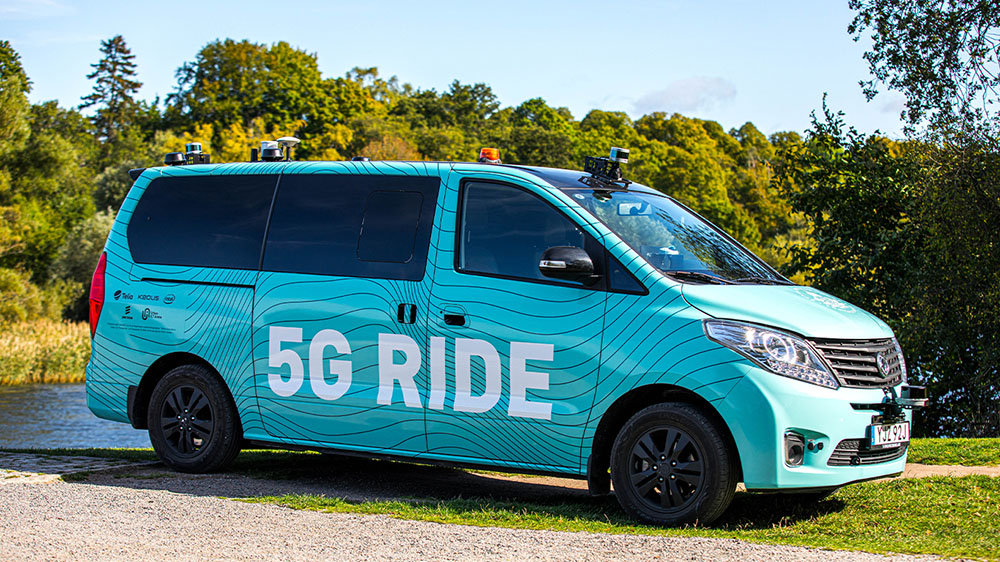Aqua blue minivan with 5G Ride printed across side door panels