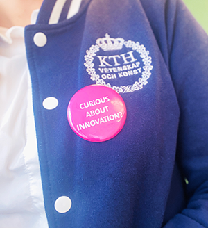 A sweatshirt with a KTH logo and a pink pin with the text "Curious about innovation"?