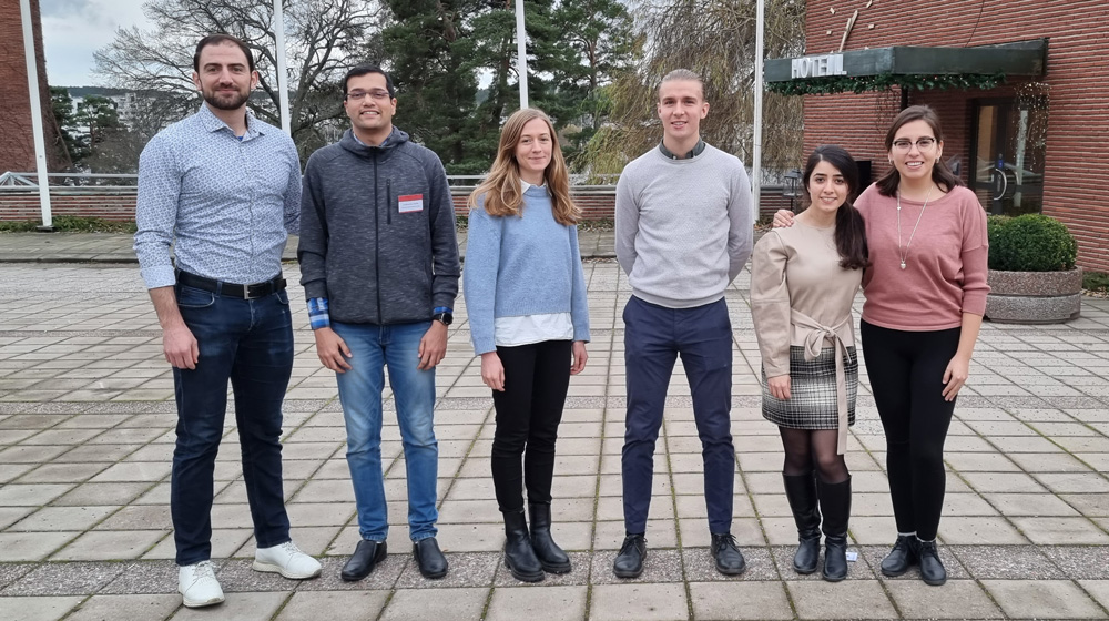 ITM's young researchers in front of a building