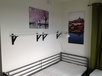 90 cm bed with two pictures on the wall and nightstand beside.