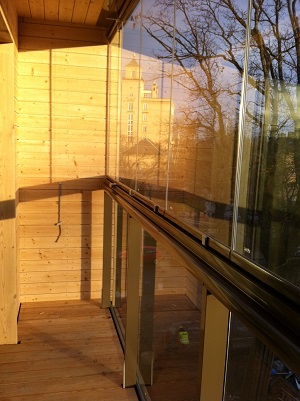 Glassed-in wooden balcony with sunshine