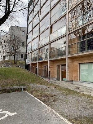 View of side of building and bottom floor apartments from outside