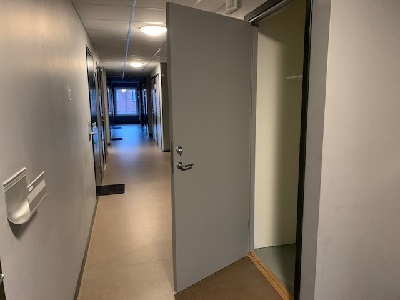 Open closet door in indoor hallway