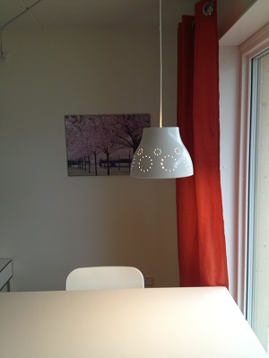 Table by window with lamp hanging over it