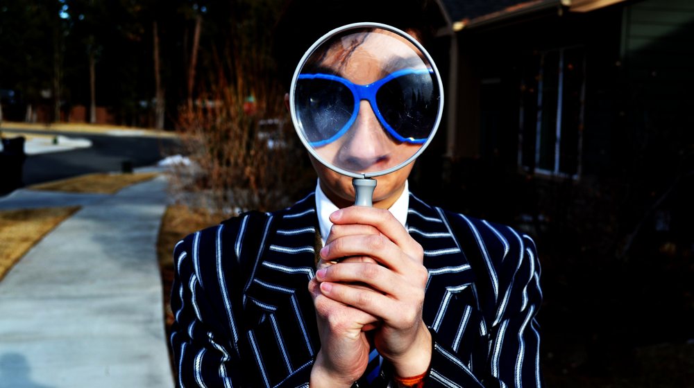 Woman holding a magnifying glass.