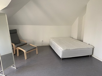Apartment with armchair and bed.