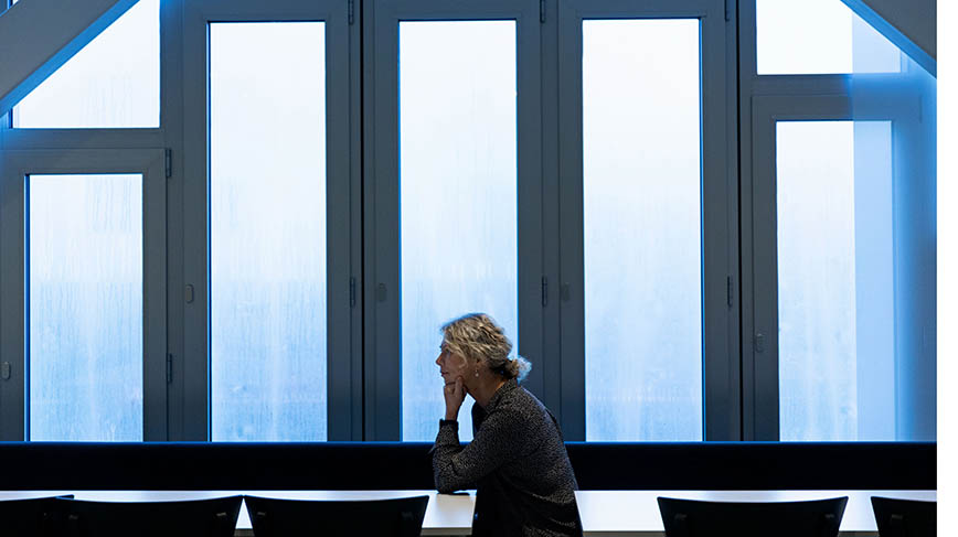 Annika Vänje i profil i skugga mot fönster under takbjälkar