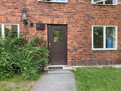 Brown door entrance in red brick building.
