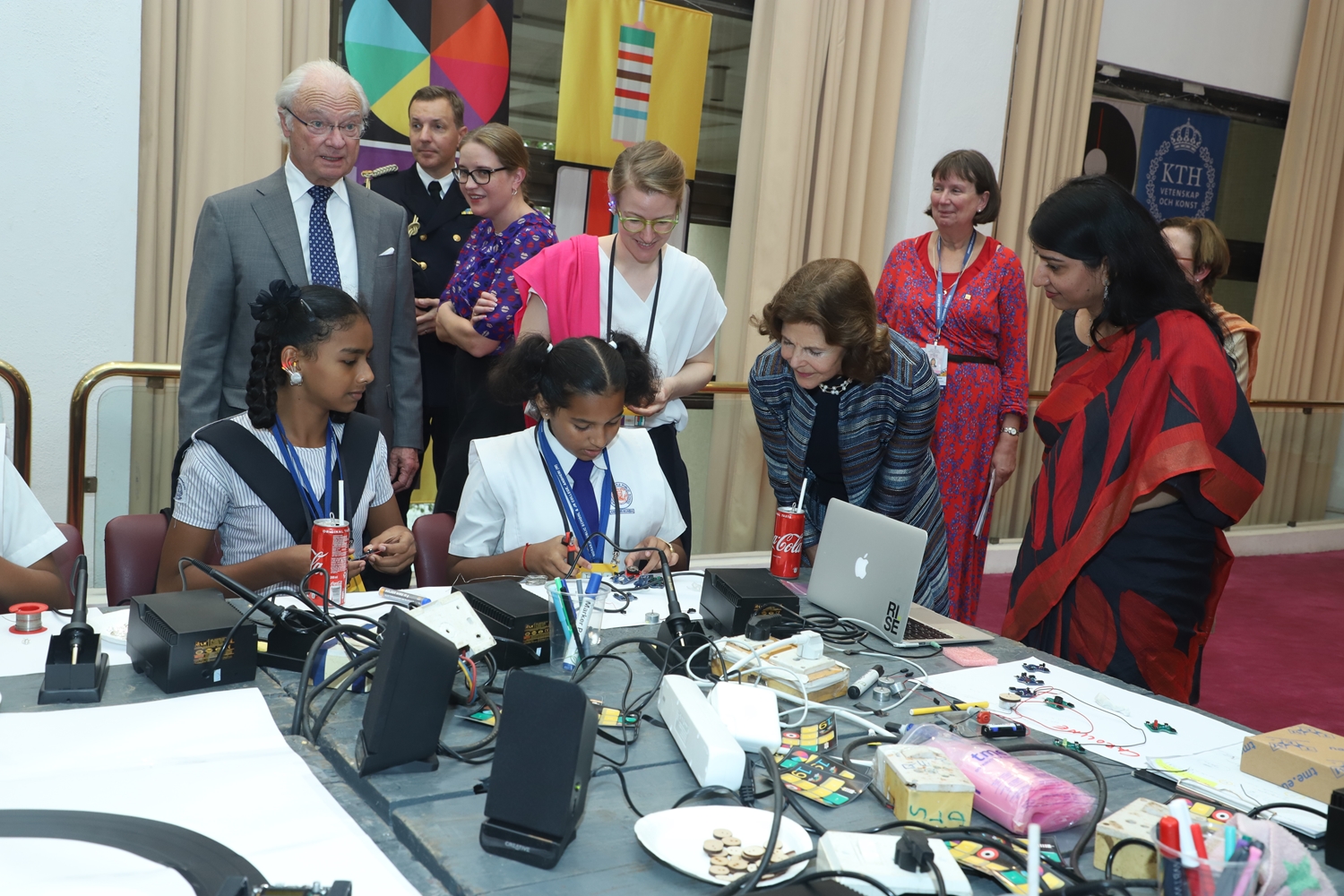  H.M. King Carl XVI Gustaf, Caroline Dahl and H.M. Queen Silvia watches as two girls experiment