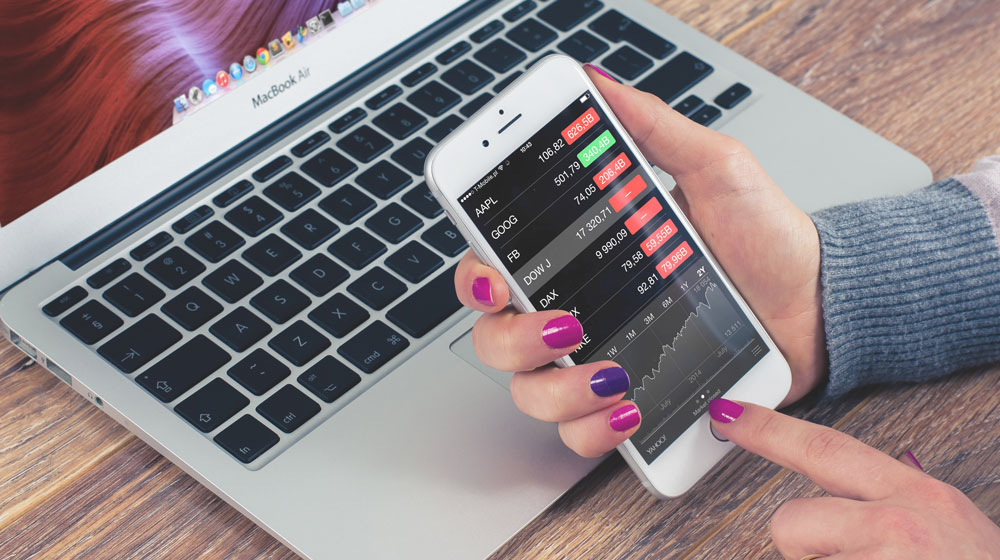 Woman looking at the stock in front of computer.