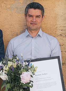 Rustam Nabiev with flowers and diploma