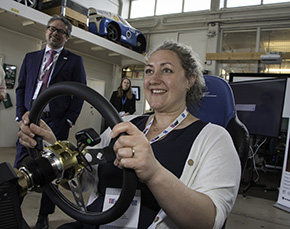 A woman behind a steering wheel.