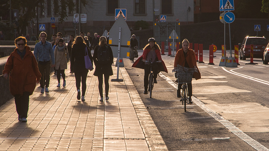 Walking people and bicycles in city street