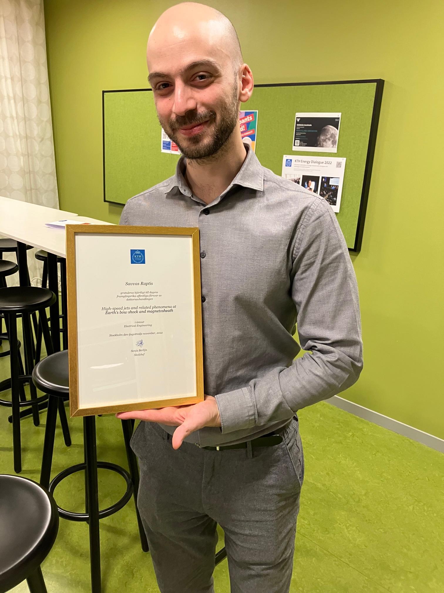 Savvas with his diploma after the successful defense.