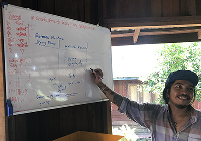 a coffee grader in front of white board with written information