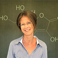 A woman standing in front of a blackboard