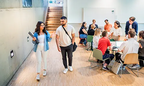 Studenter på campus som pluggar ihop.
