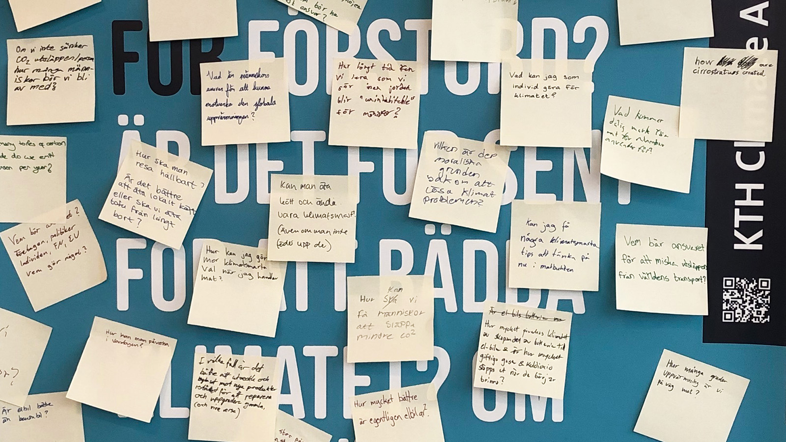 Picture of post-it notes with questions about the climate crisis written by students