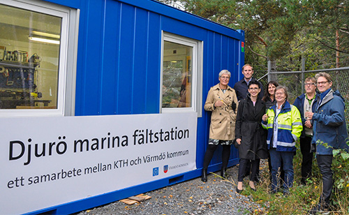 People-posing-beside-container-field-station