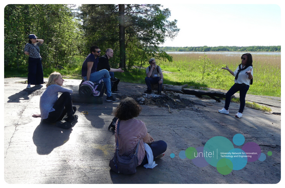 A group of people sitting on a rock