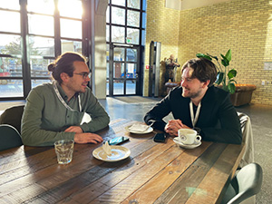 Two men talking at a table