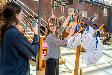 Doctoral student hanging up her dissertation