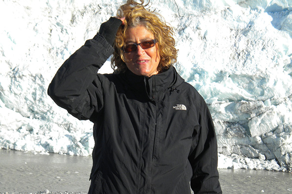 woman standing in front of a glacier on Greenland