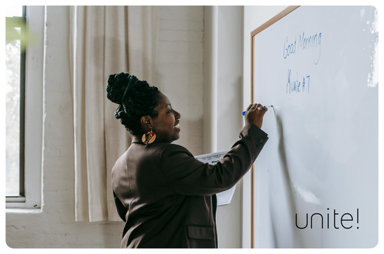 A woman writing on a whiteboard