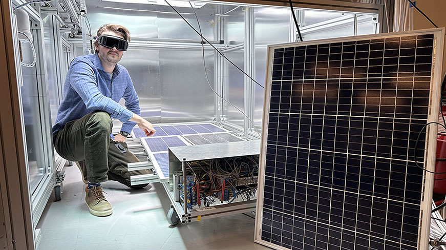 Researcher next to the solar simulator