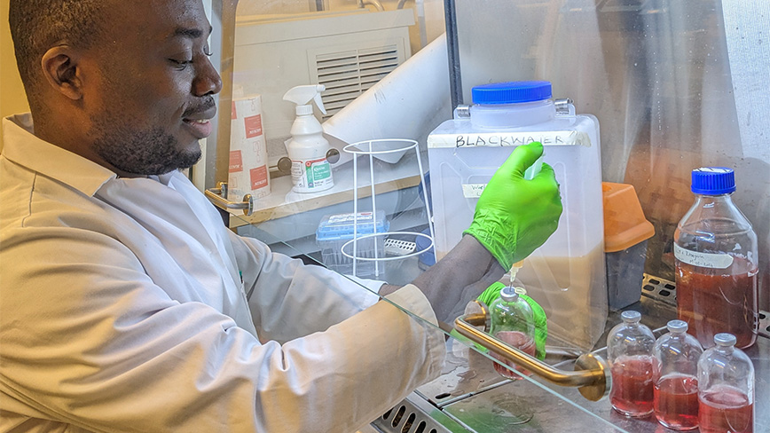 Researcher working in a fume hood.