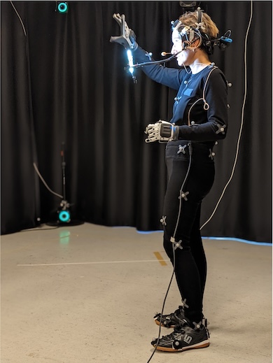 a woman wearing motion detection devices and trying to make a gestures to be recorded