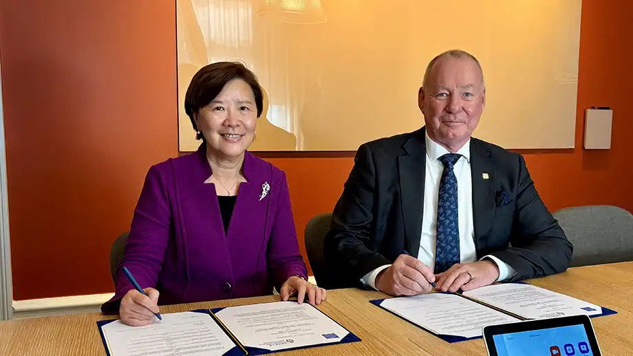 A man and a woman signing documents.