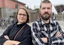 Woman and man with arms crossed.