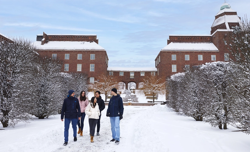 Students in a snowy KTH courtyard