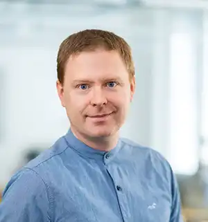 Portrait photo of man in blue shirt.