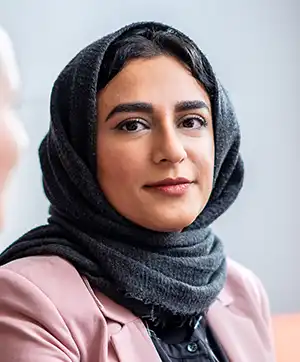 Portrait of woman with head scarf.