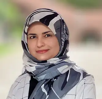 Portrait photo of woman with head scarf with pattern.