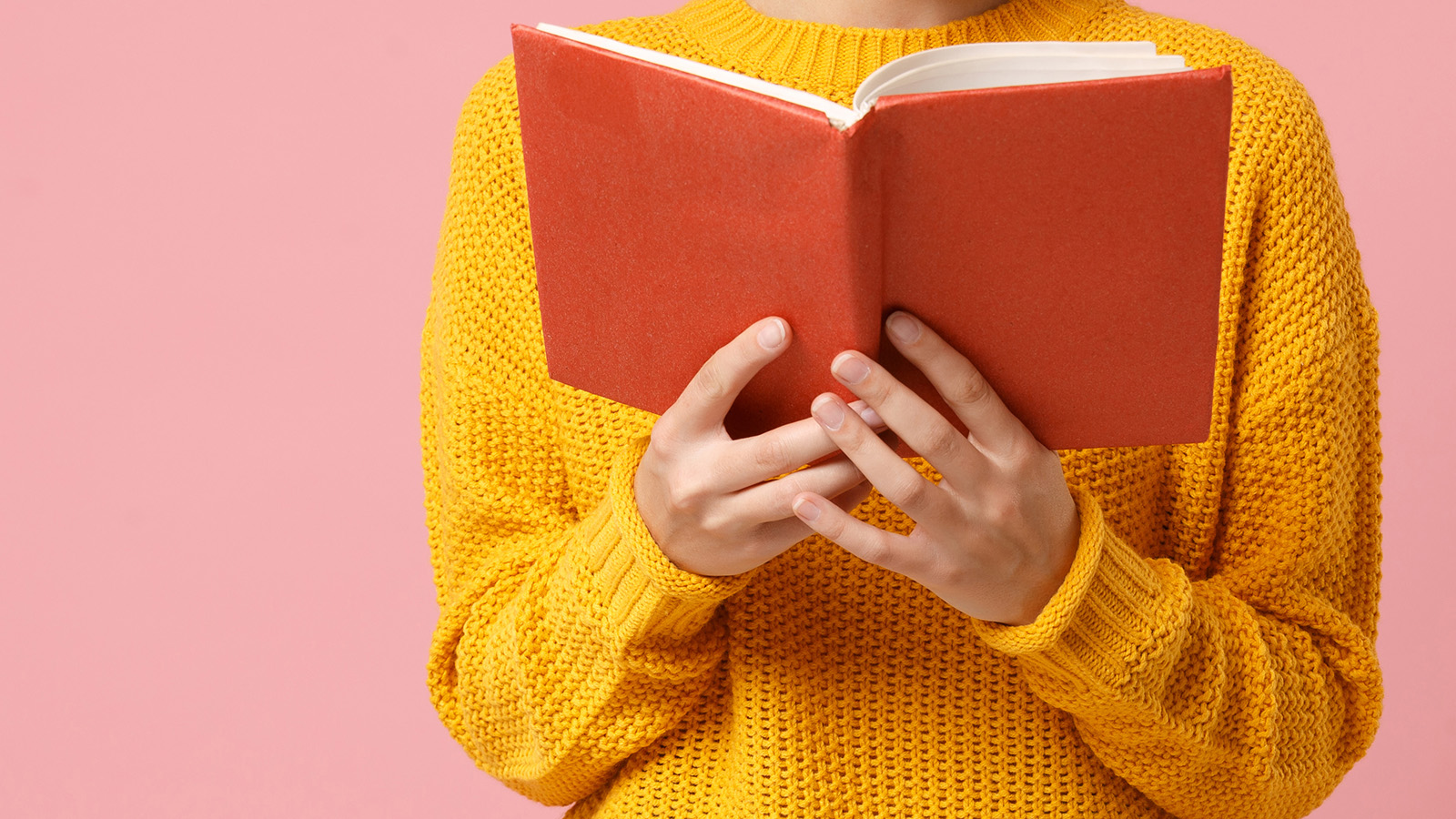 Person holding up a book