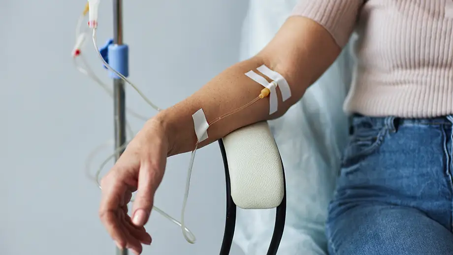 A patient receiving a drug transfusion at a clinic.
