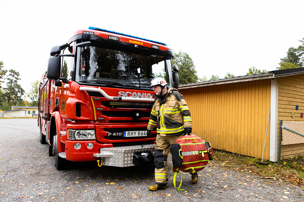 Firef fighter in front of fire truck 