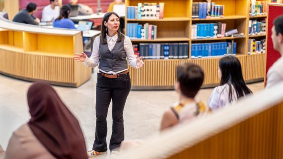 A librarian speaks to students