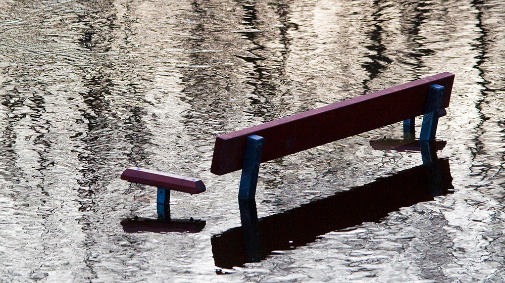 A bench drenched in water
