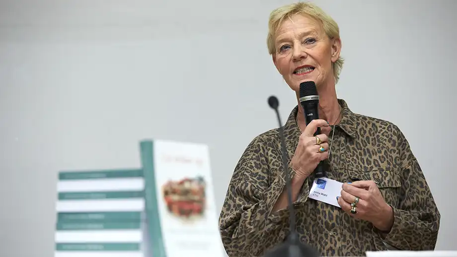 A woman talking in a microphone.