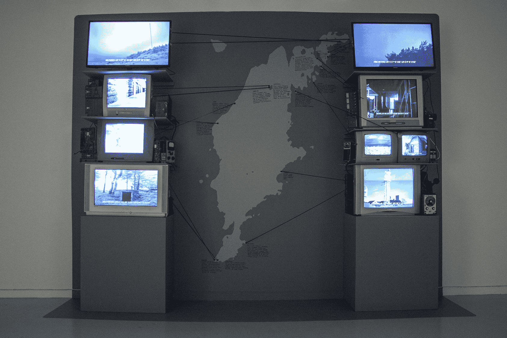 CRT displays with arrows pointing to a map