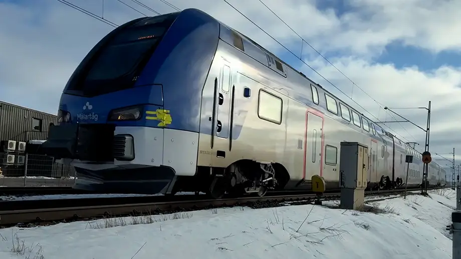 A train speeding down tracks in the winter