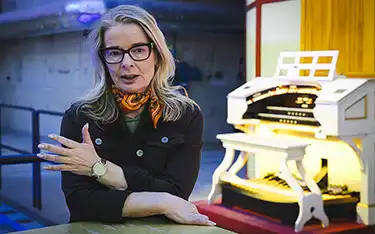 A woman behind a table.