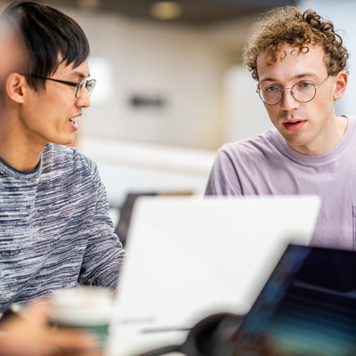 Two persons in front of a computer