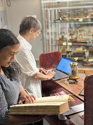 Two librarians works in the rare books collection.