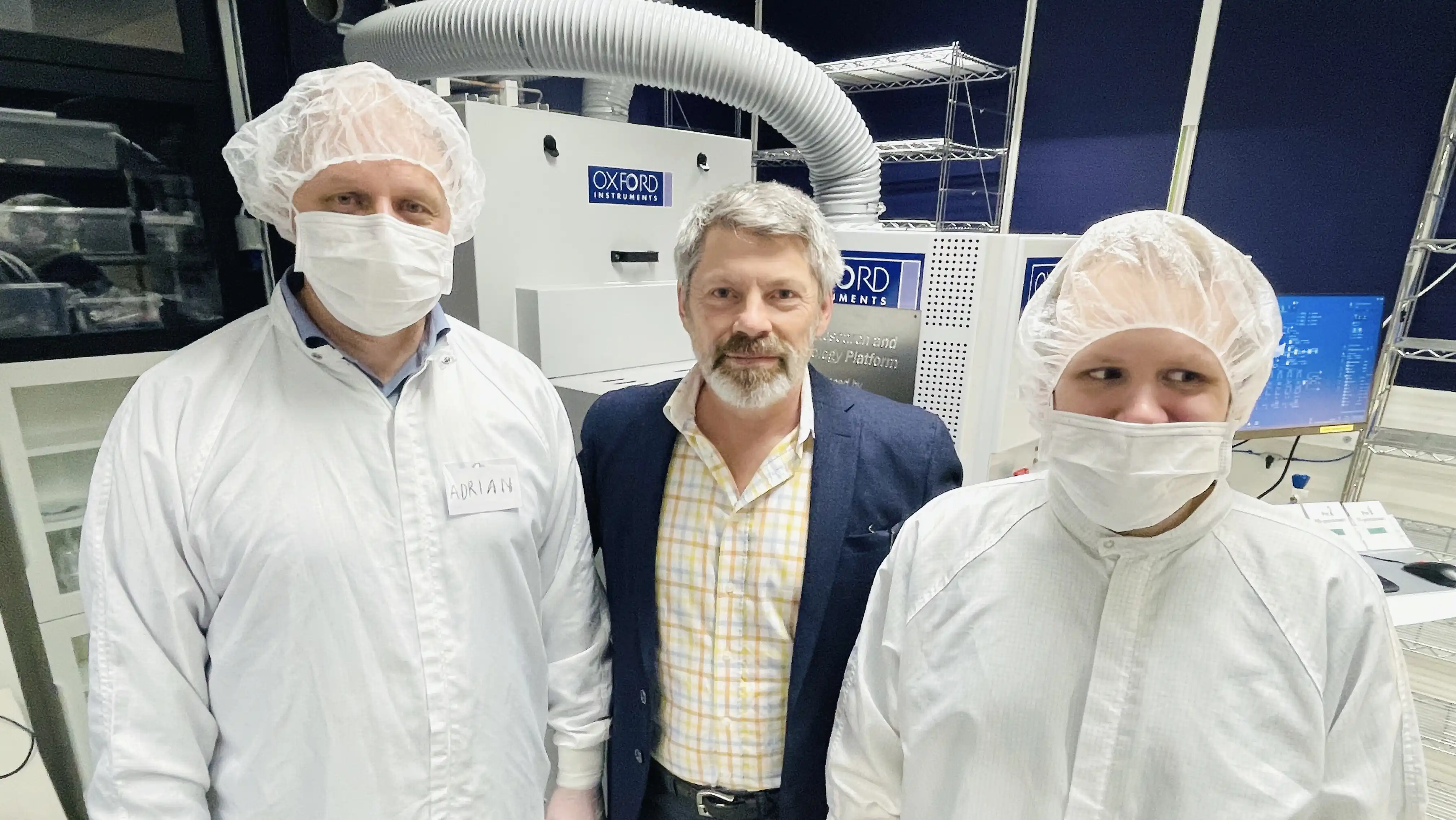 three men in a lab