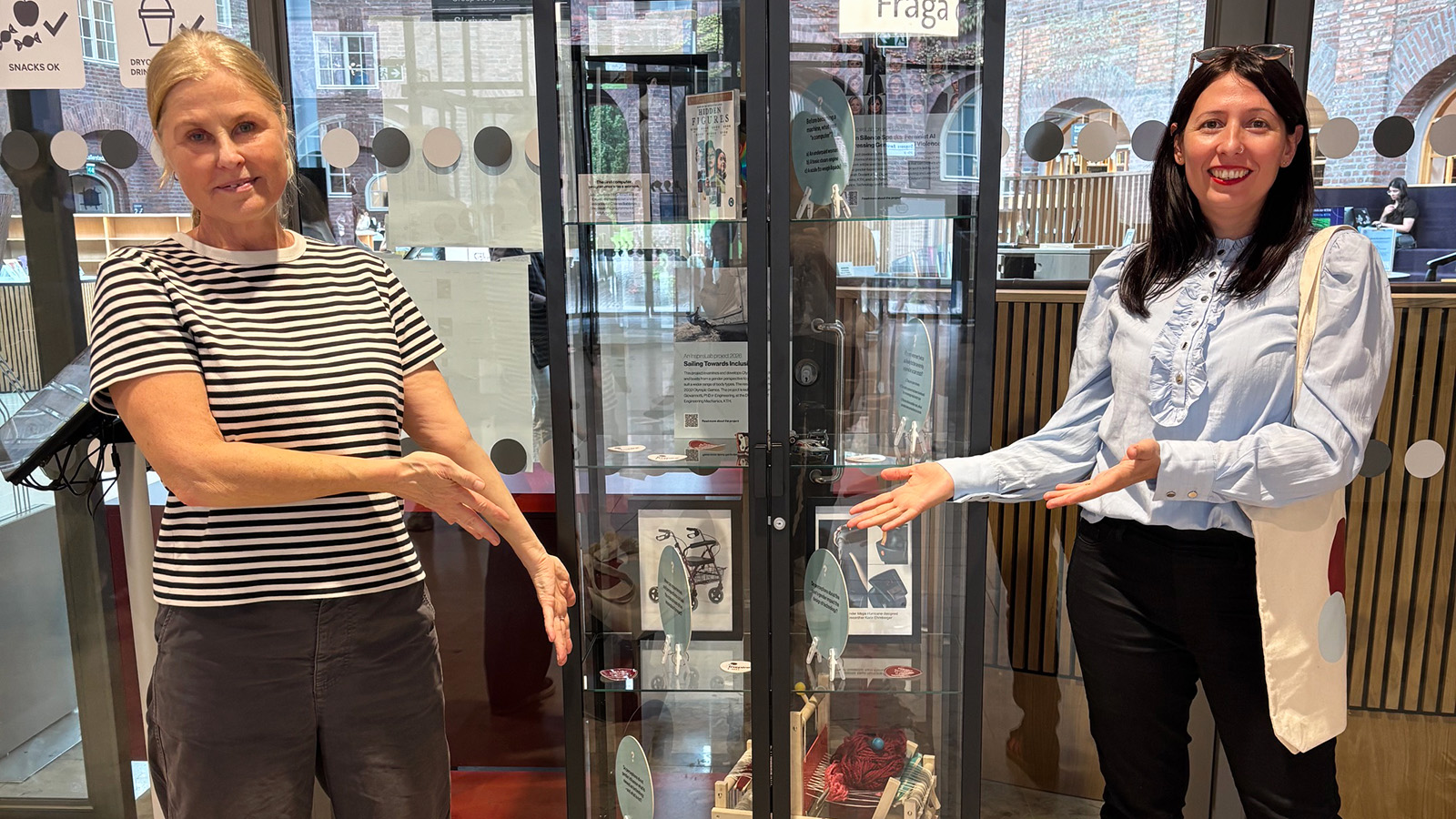 Two people in front of an exhibition showcase